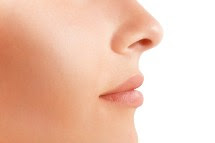 a close up of the side of a woman's face showing her cheek, mouth, and nose