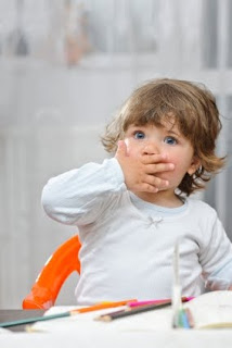 Toddler covering their mouth