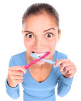 Woman brushing her teeth with two toothbrushes