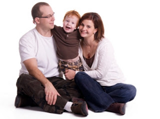 Family of three smiling for a picture