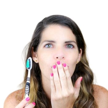 Closeup of an attractive young woman with a toothbrush